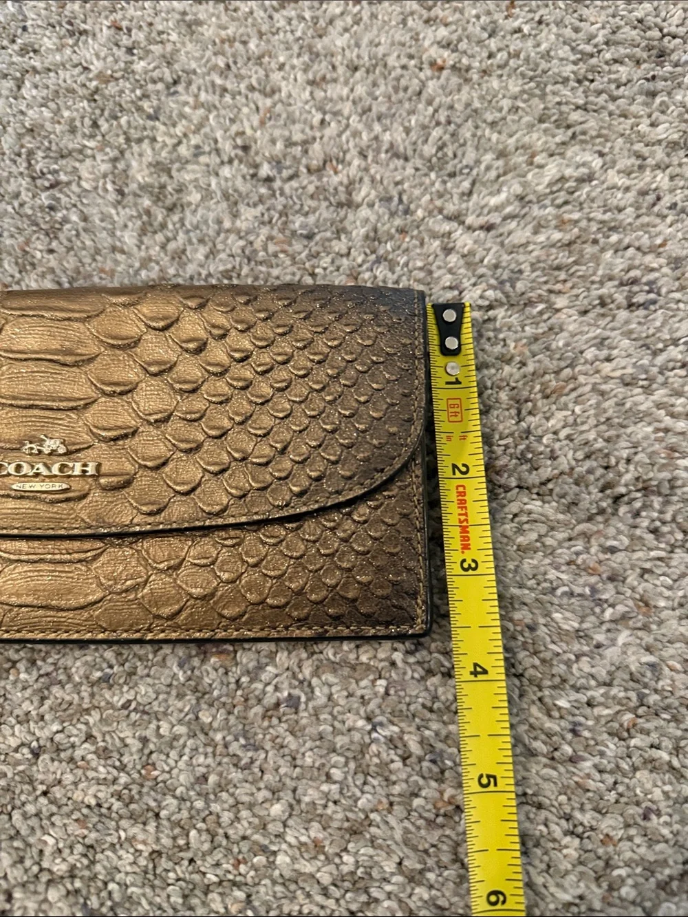 Coach Metallic snake-embossed leather envelope wallet in a muted gold tone